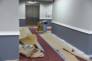 professional commercial painting services Hesperia, CA hallway with red carpet and gray walls.